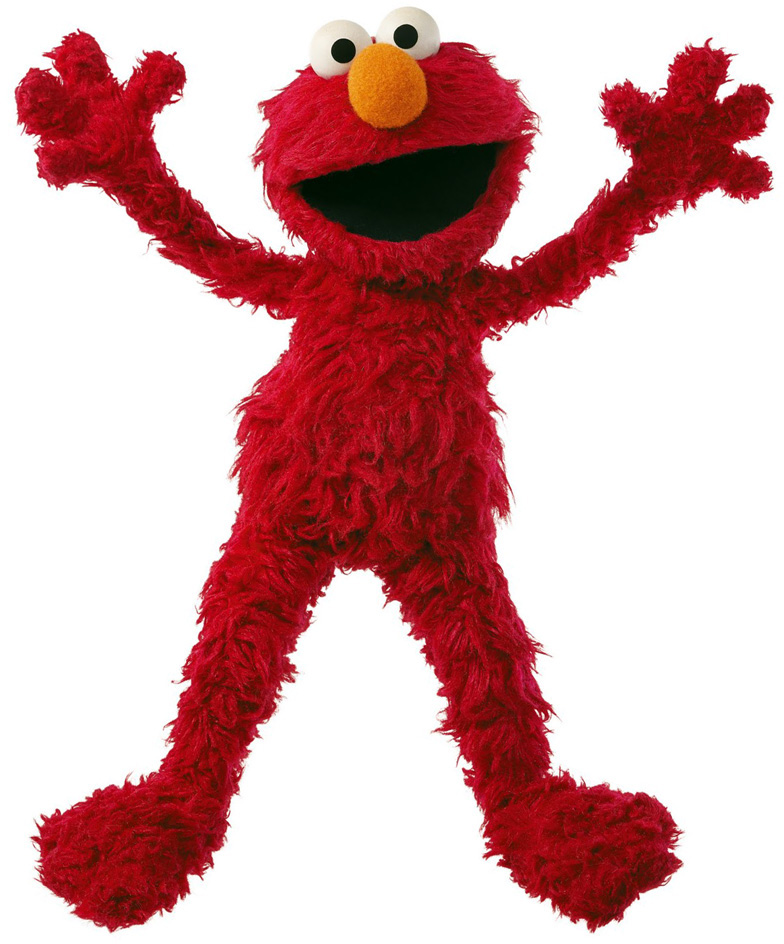 Elmo is a monster muppet. Except for his globular orange nose he is entirely covered with shaggy, bright red fur.  He has four fingers on each hand, and a huge smile. In this picture he is standing with legs apart and arms outstretched.